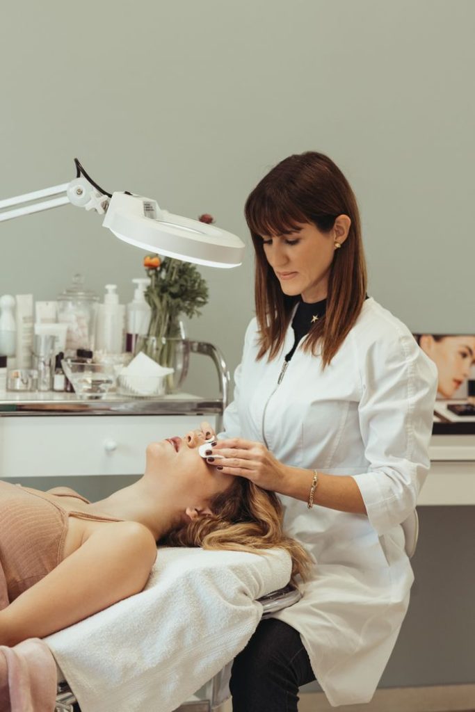 pexels-photo-16120490 A cosmetologist performing skincare procedures on a client in a salon setting.