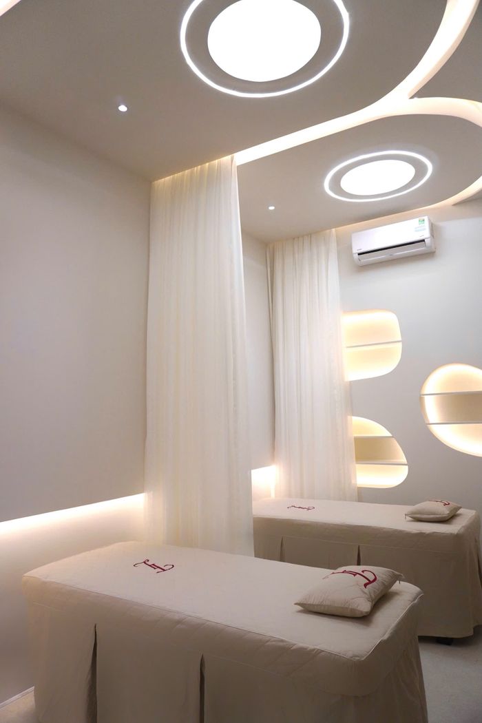 Luxurious spa room with massage tables and ambient lighting for relaxation.